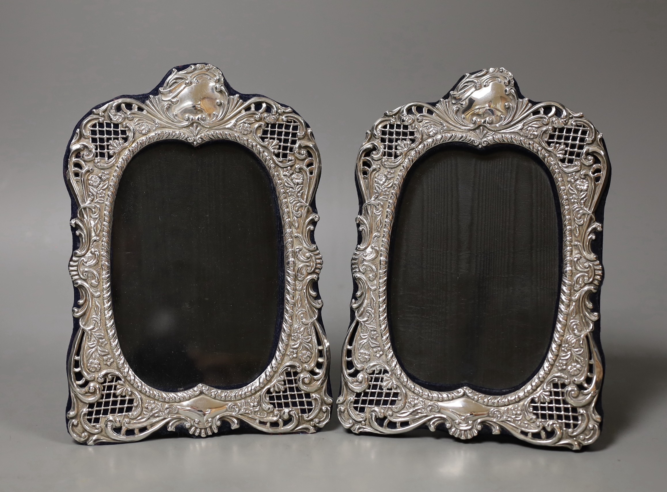 A pair of Edwardian repousse silver mounted photograph frames, by Robert Chandler, Birmingham, 1901, 20.5cm.